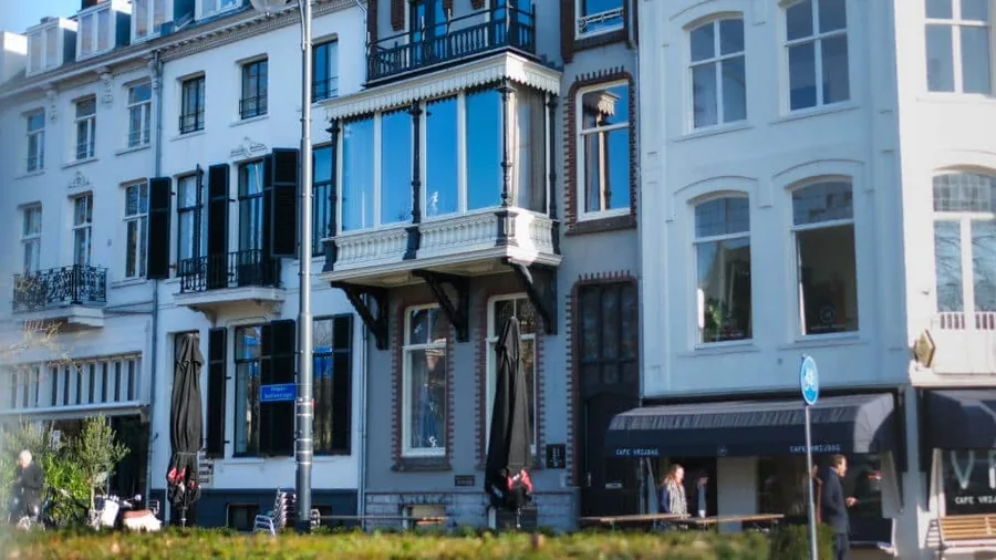 Een negentiende-eeuws herenhuis met blauwe erkers waarin een van de vestigingen zit