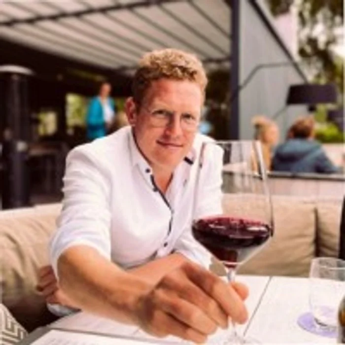 Maurice Lemoine, bedrijfsleider van De Veranda, aan een tafel op het terras
