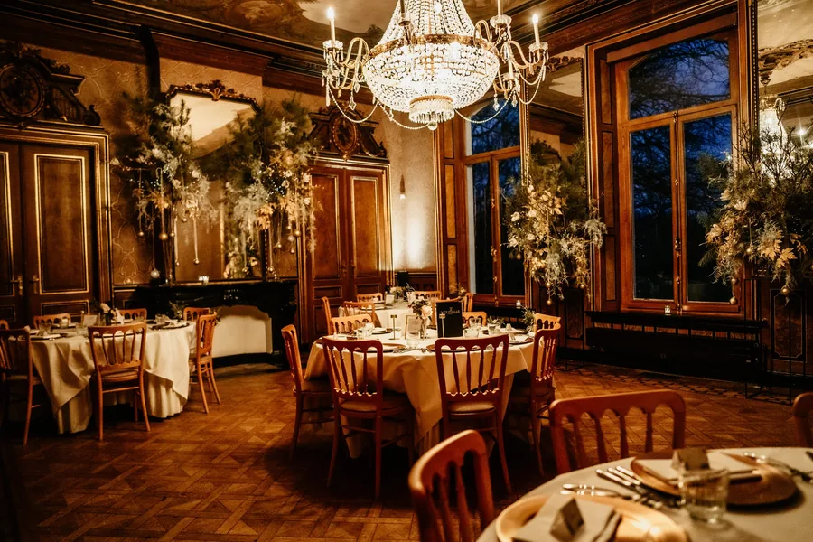 Gedekte tafels onder de kroonluchter in een van de salons